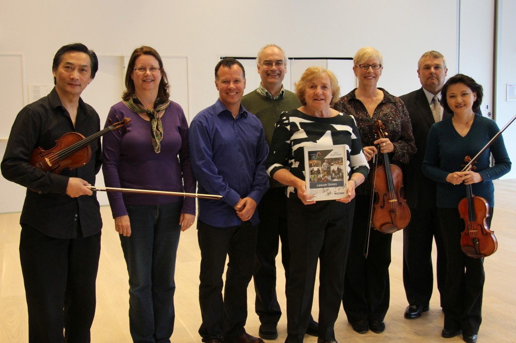 Left to Right: Yi Lee (Violin), Peggy Walt, Norm Adams (Cello), Max Kasper (Host and Double Bass), Rose Wilson (sponsor), Susan Sayle (Viola), Chris Wilkinson (General Manager, SNS) and Anita Gao-Lee (Violin), at the new Paul O’Regan Hall at Halifax Central Library this May.
